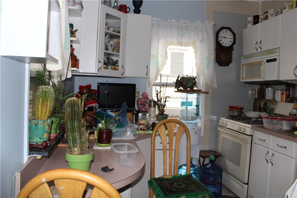 6 Brighton 10th Terrace Brooklyn, NY 11235 - Photo 6 of 8 a kitchen with sink refrigerator and stove