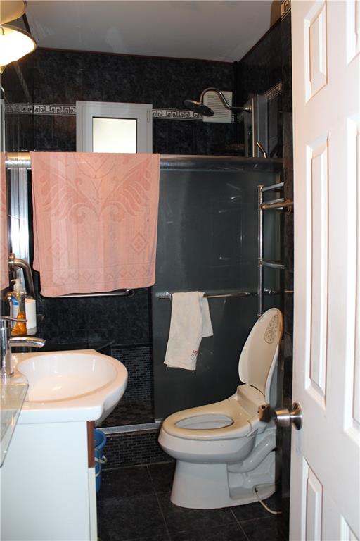 6 Brighton 10th Terrace Brooklyn, NY 11235 - Photo 7 of 8 a bathroom with a sink toilet and a shower