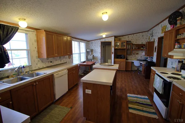 a kitchen with stainless steel appliances sink stove microwave and cabinets