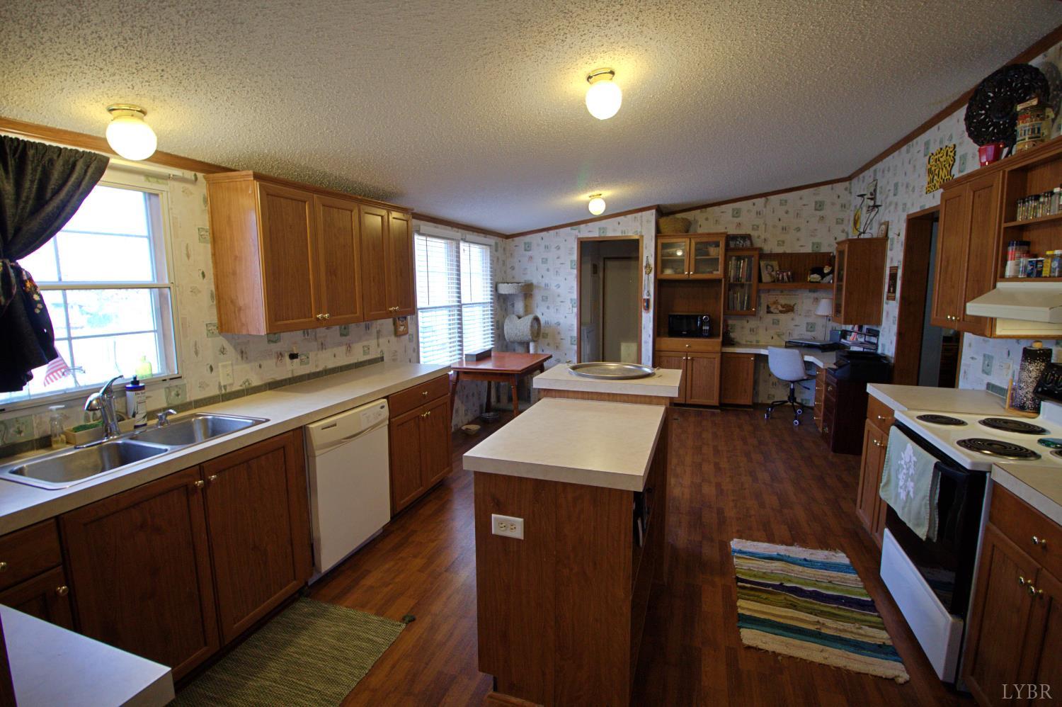 2112 Morning Star Road Appomattox, VA 24522 - Photo 15 of 24 a kitchen with stainless steel appliances sink stove microwave and cabinets