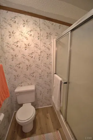 a bathroom with a toilet and a shower