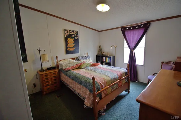 a bed room with a bed and a window