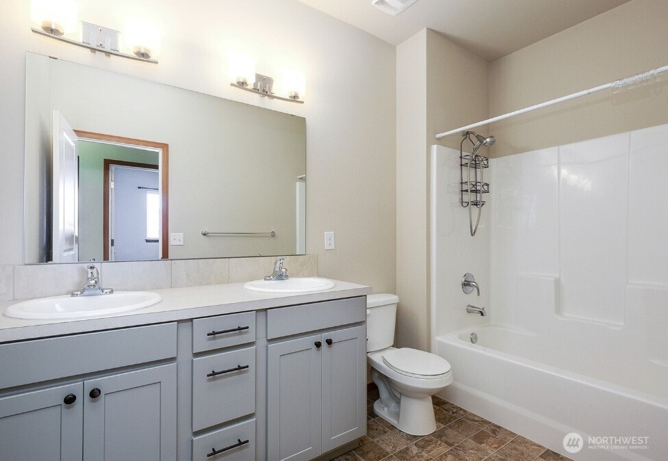 2425 Schley Boulevard Bremerton, WA 98310 - Photo 13 of 23 a bathroom with a sink a toilet and shower