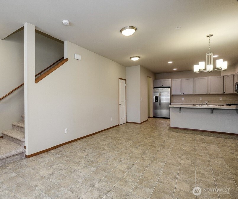2425 Schley Boulevard Bremerton, WA 98310 - Photo 6 of 23 a view of a kitchen with a fridge and wooden floor