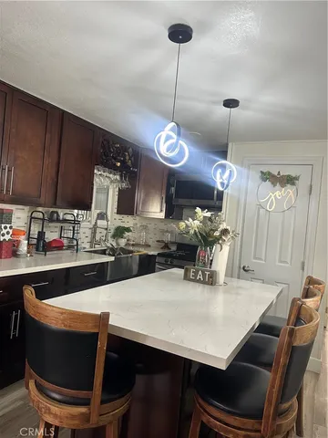 a kitchen with a dining table chairs and white cabinets