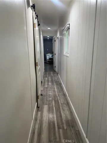 a view of hallway with wooden floor