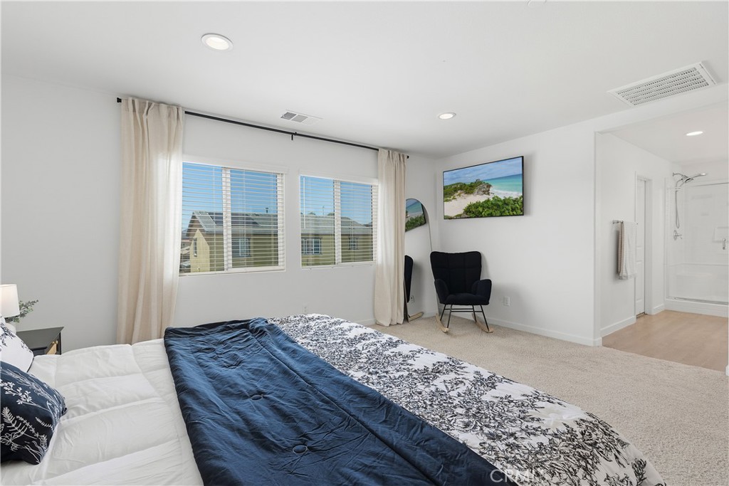 34727 Ribbon Grass Way Murrieta, CA 92563 - Photo 15 of 54 Bright primary suite with picture windows, linen drapes, black rods, and recessed lighting.