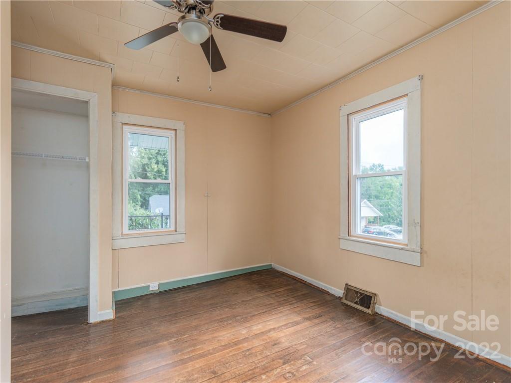 155 Substation Road Canton, NC 28716 - Photo 7 of 28 a view of empty room with wooden floor and fan