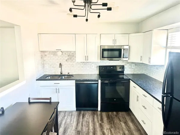 a kitchen with stainless steel appliances granite countertop a stove and a sink