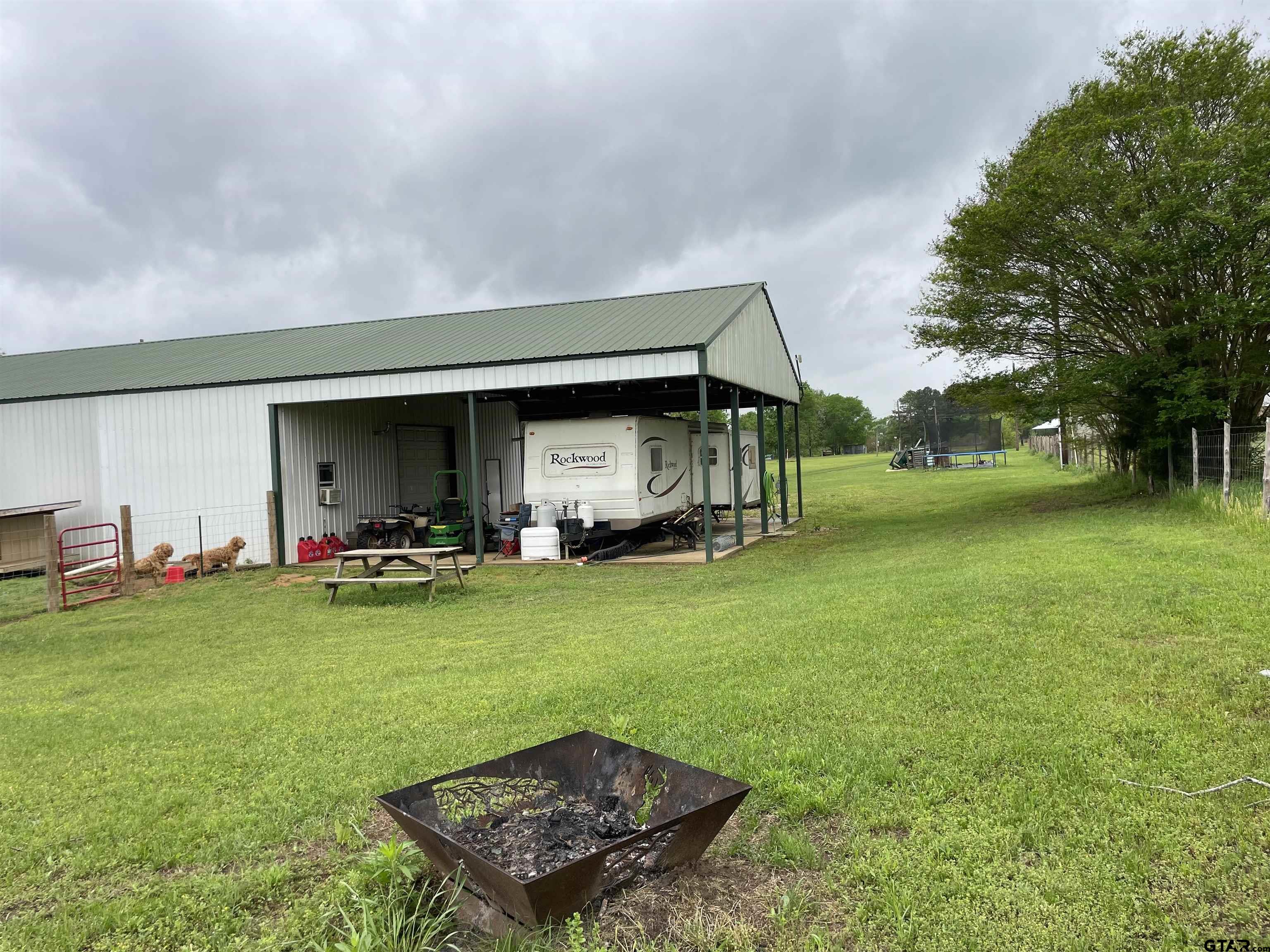677 South Chandler Street Rusk, TX 75785 - Photo 14 of 16 a view of a backyard with table and chairs and a barbeque