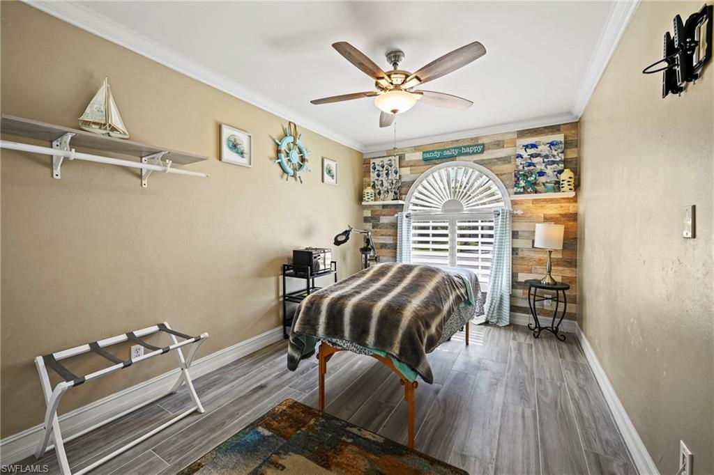 21684 Brixham Run Loop Estero, FL 33928 - Photo 12 of 26 Bedroom with ornamental molding, wood finished floors, and a ceiling fan
