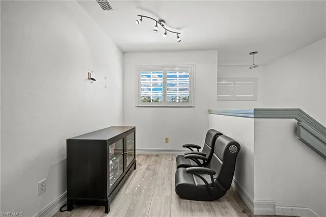 a hallway with furniture and a window