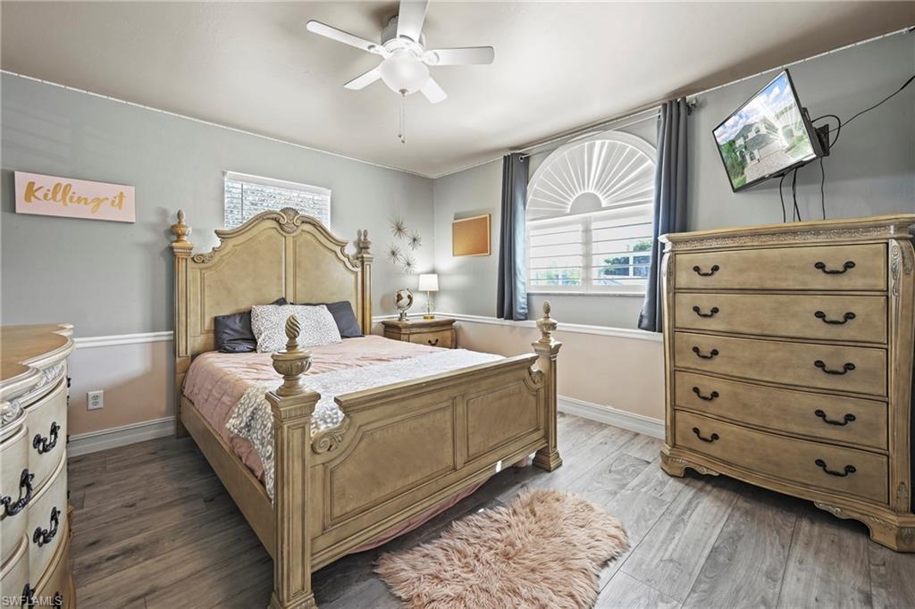 21684 Brixham Run Loop Estero, FL 33928 - Photo 18 of 26 Bedroom with ceiling fan and wood finished floors