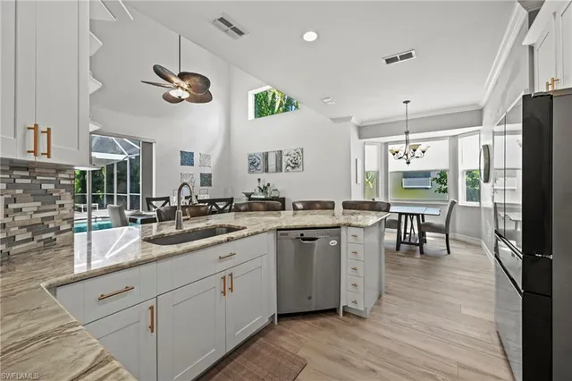 a kitchen with a sink appliances and cabinets