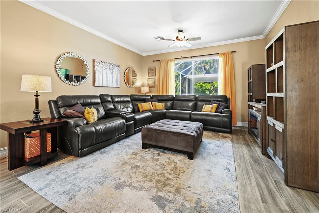 21684 Brixham Run Loop Estero, FL 33928 - Photo 6 of 26 Living area featuring crown molding, light wood finished floors, and a ceiling fan