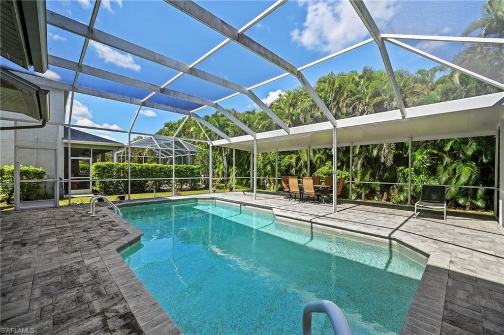 21684 Brixham Run Loop Estero, FL 33928 - Photo 9 of 26 Outdoor pool with a lanai, a sunroom, and a patio area