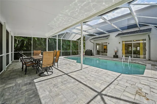a patio with yard glass top table and chairs