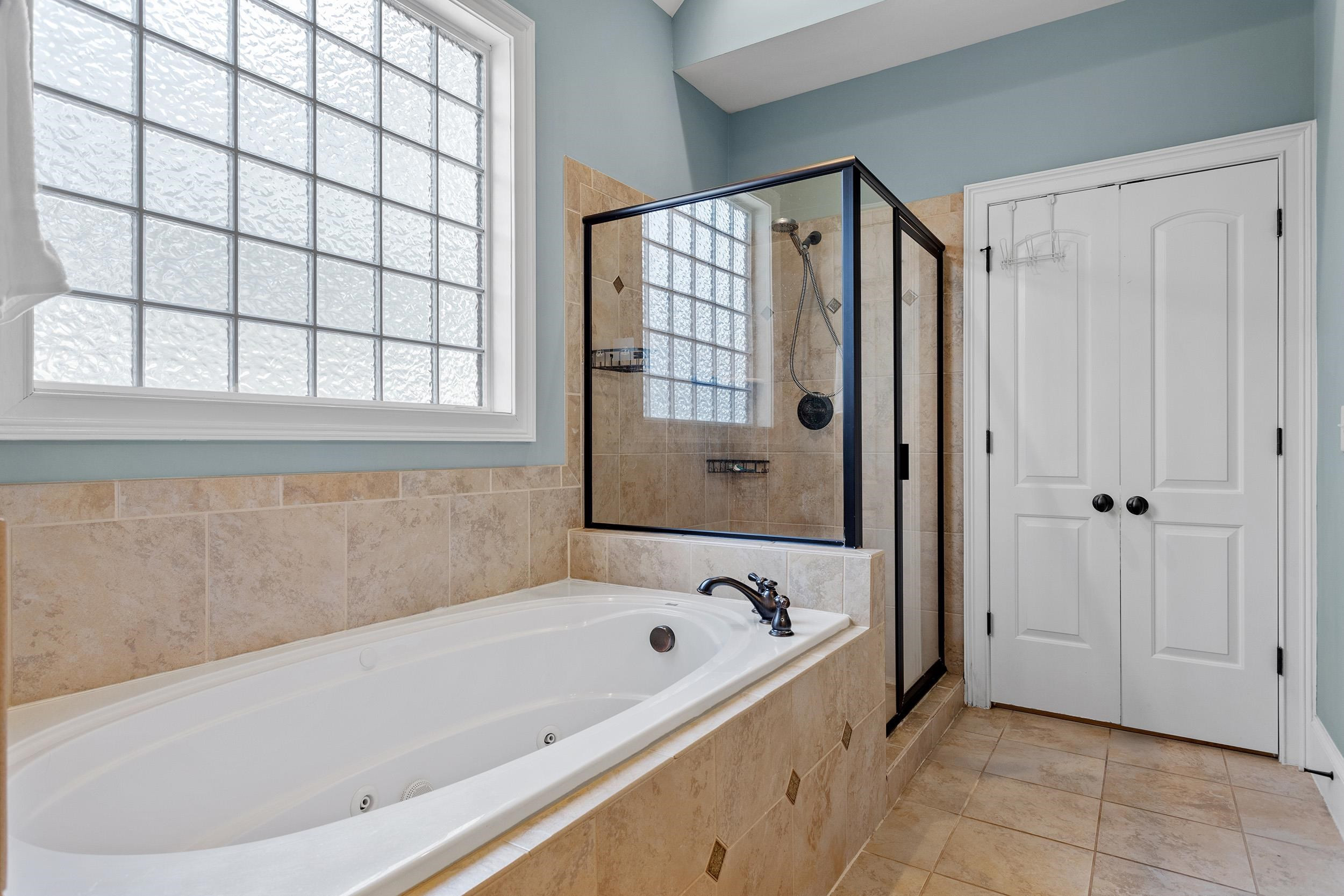 1312 Ileagnes Road Raleigh, NC 27603 - Photo 19 of 34 a bathroom with a bathtub and a shower