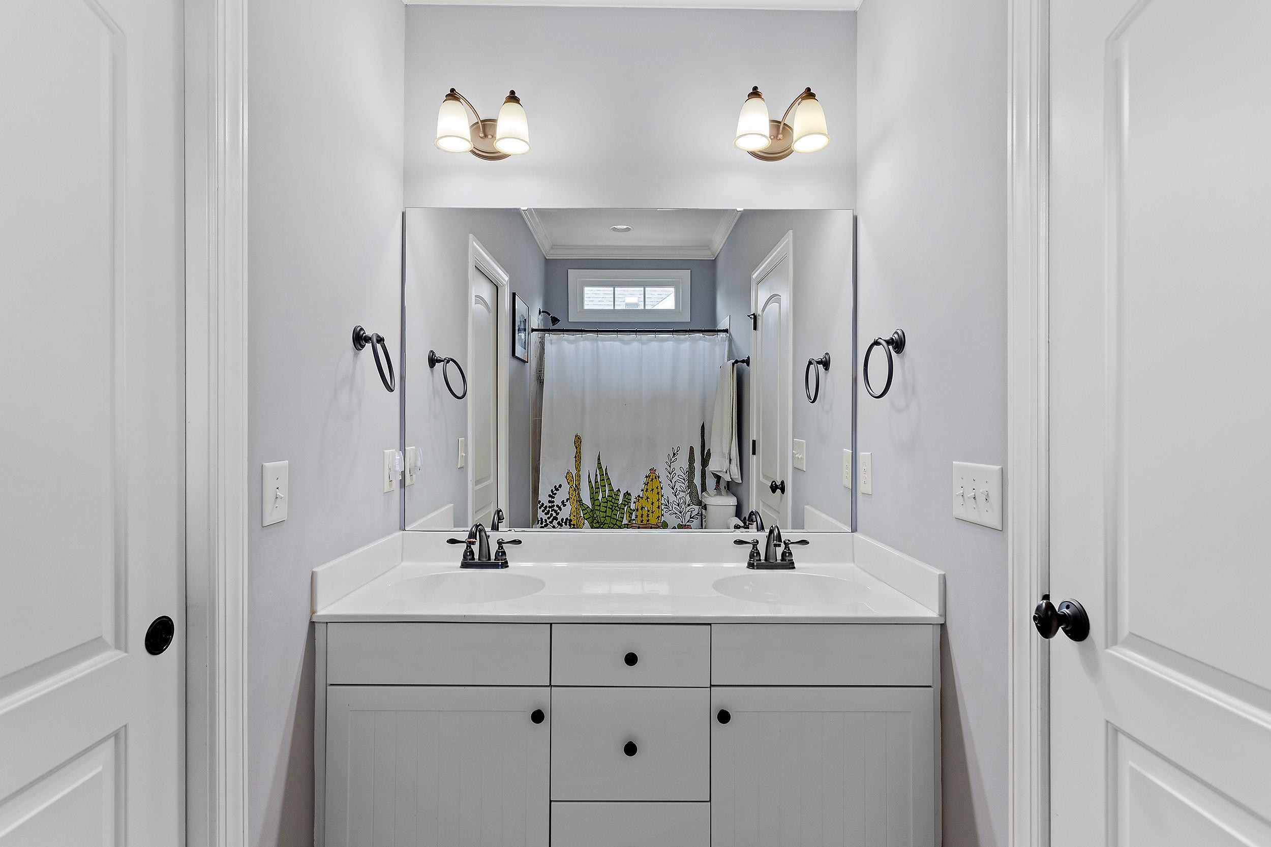 1312 Ileagnes Road Raleigh, NC 27603 - Photo 23 of 34 a bathroom with double vanity sink and a mirror