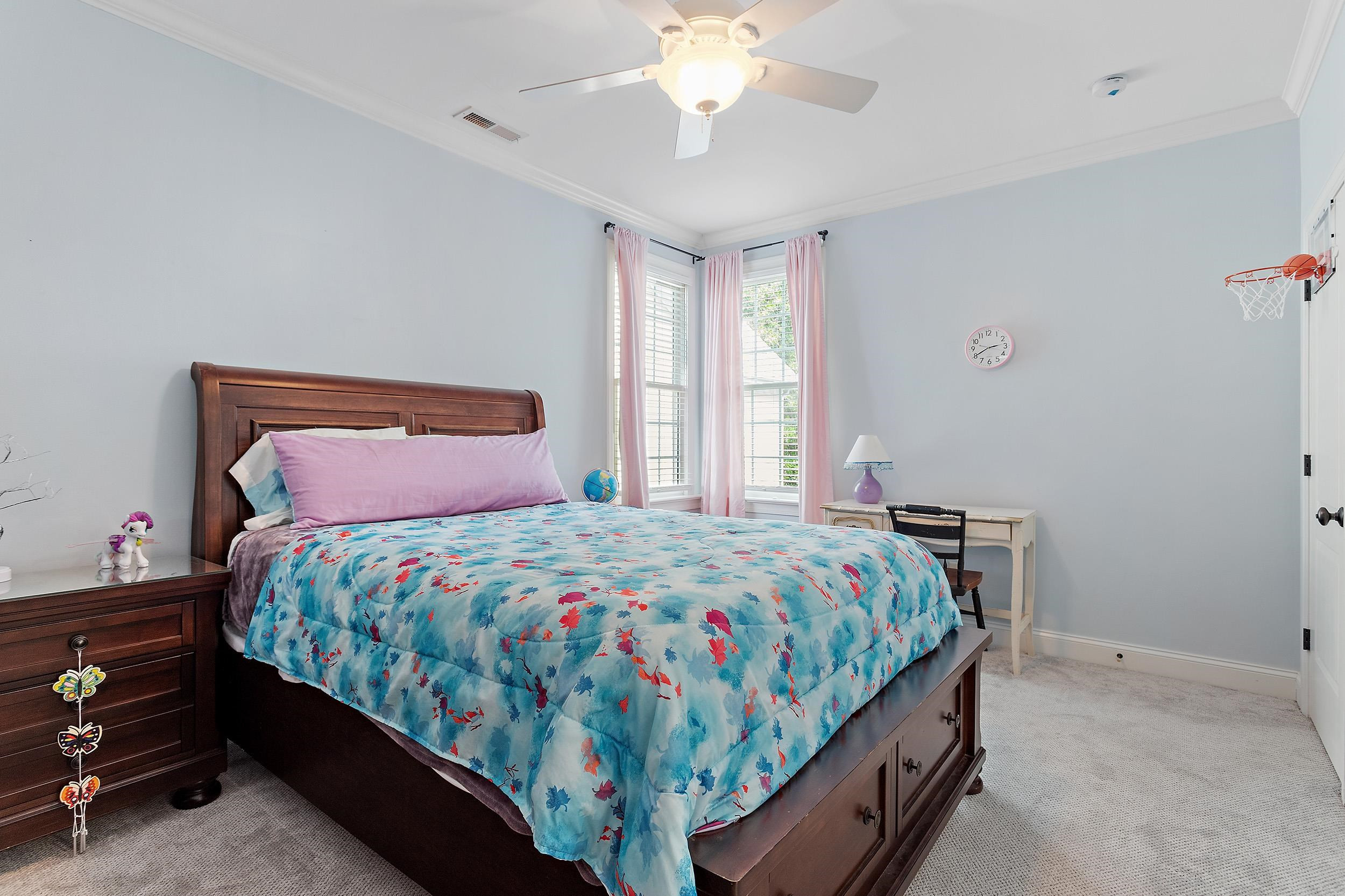 1312 Ileagnes Road Raleigh, NC 27603 - Photo 24 of 34 a bedroom with a bed and a chandelier
