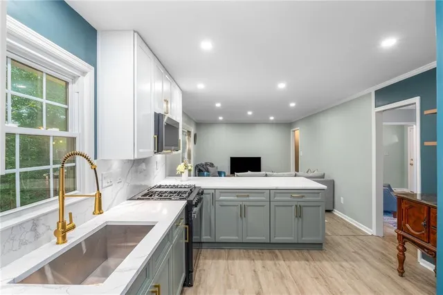 a kitchen with a sink stove and cabinets