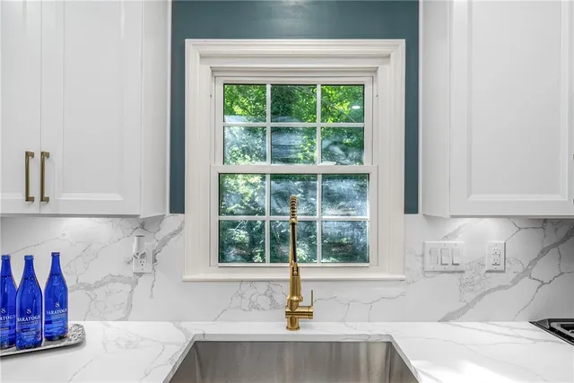a bathroom with a tub sink and window