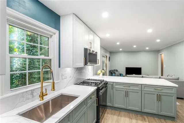 a kitchen with a sink stove and cabinets