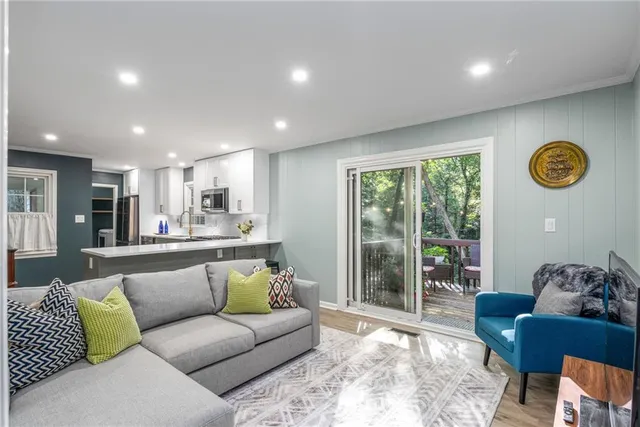a living room with furniture and a floor to ceiling window