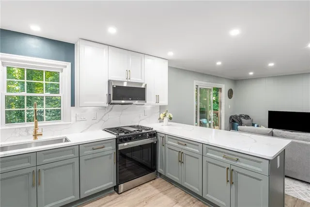 a kitchen with a sink stove top oven and cabinets