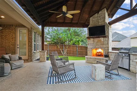 a outdoor living space with furniture and a fireplace