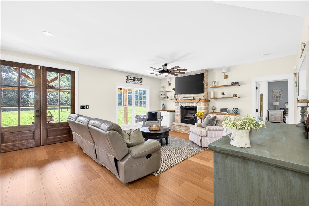 5016 Copeland Road Belton, SC 29627 - Photo 12 of 45 Natural light pours into this warm living space with a stately fireplace and hardwood floors.
