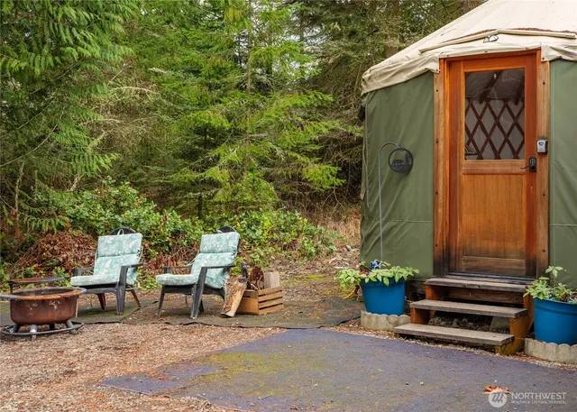 a backyard of a house with outdoor seating