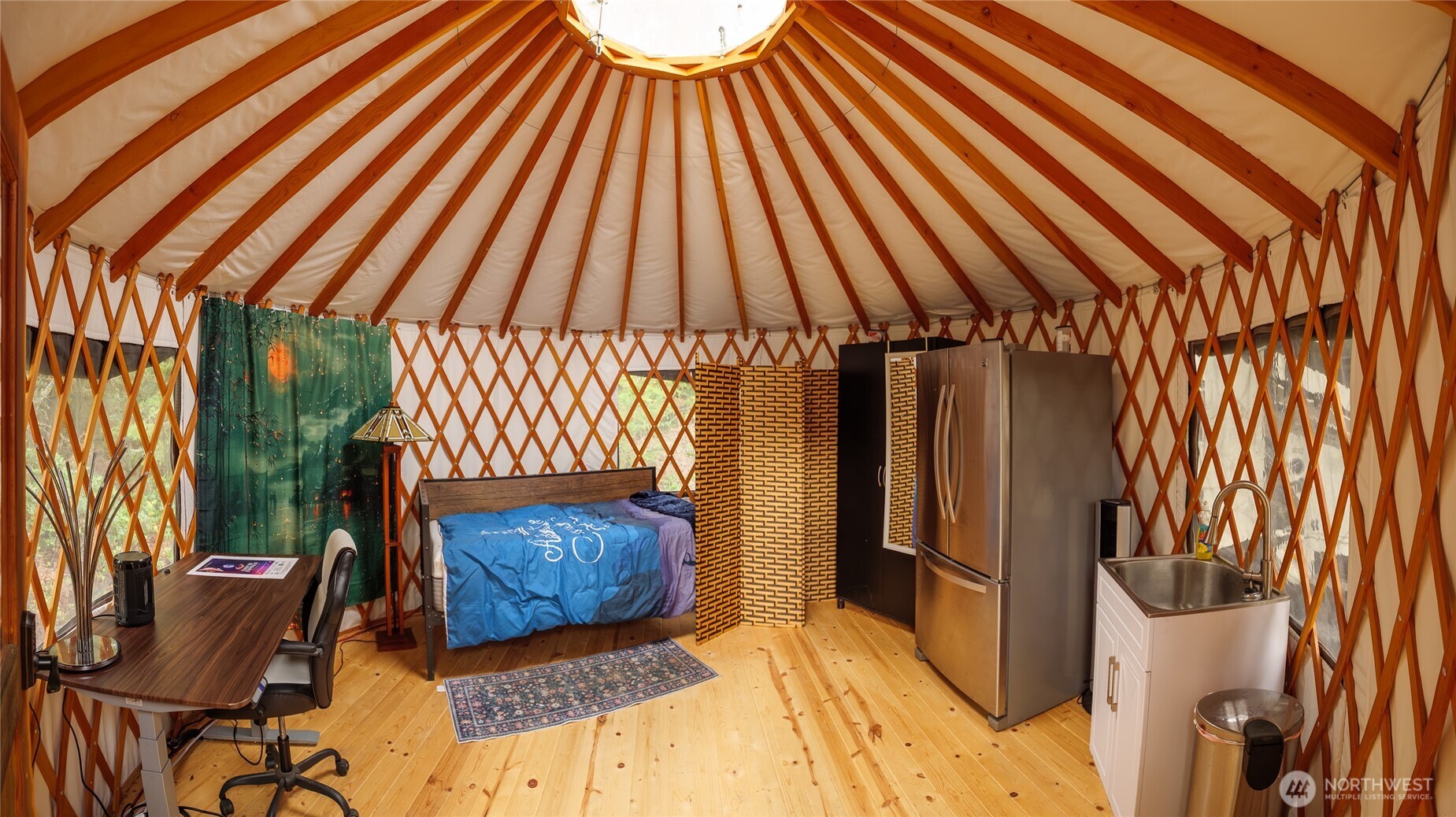 193 Springwater Lane Sequim, WA 98382 - Photo 14 of 40 a bedroom with a bed and a chandelier