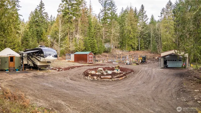 a roof deck with table and chairs and a barbeque