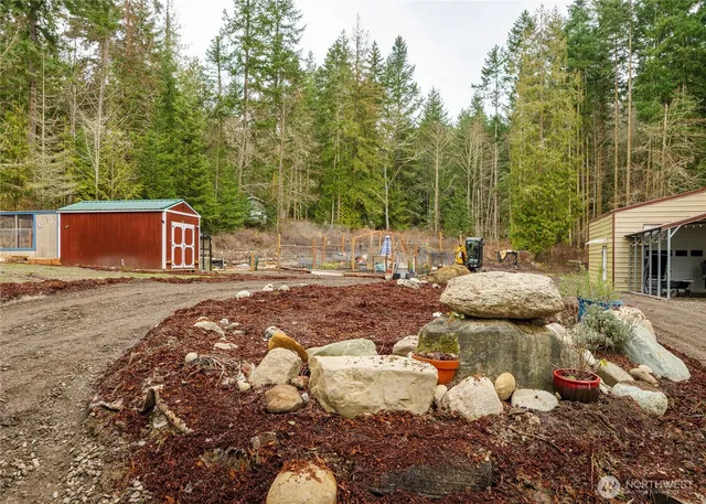 a backyard of a house with table and chairs