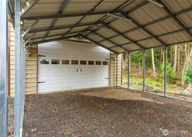 a patio with a table and chairs and potted plants