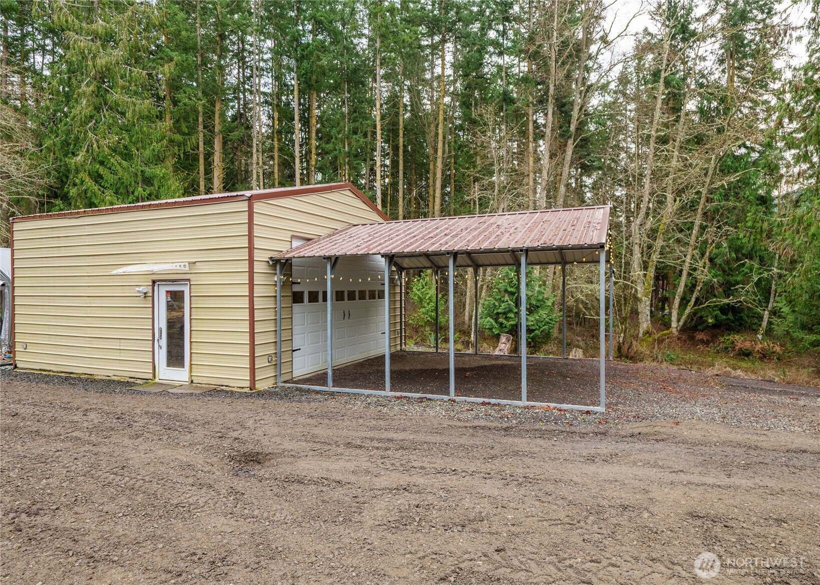 193 Springwater Lane Sequim, WA 98382 - Photo 28 of 40 a patio with a table and chairs and potted plants