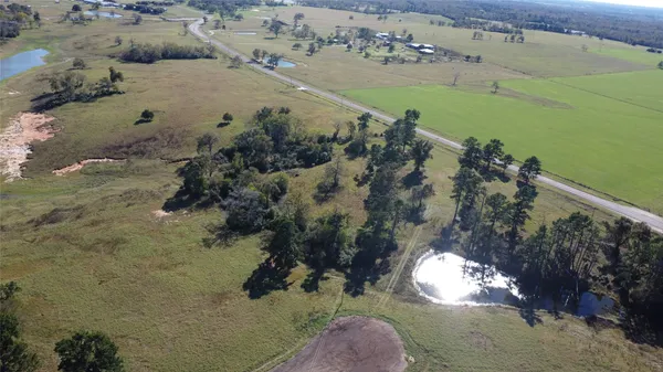 an aerial view of a houses with a yard