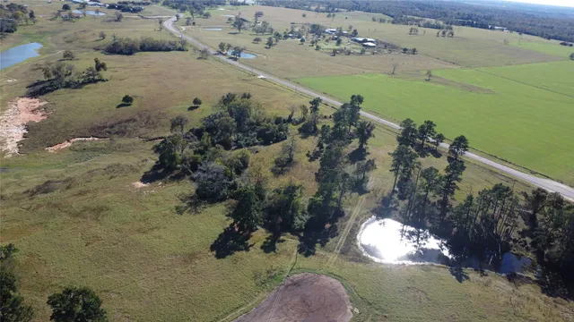 an aerial view of a houses with a yard