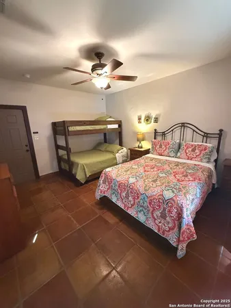 a bedroom with double bed and a chandelier