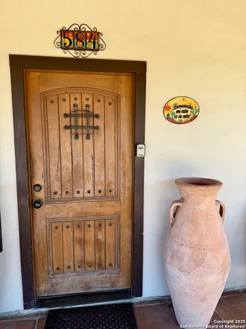 a view of a house with pool and chairs