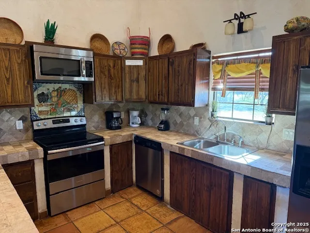 a kitchen with granite countertop a stove and cabinets