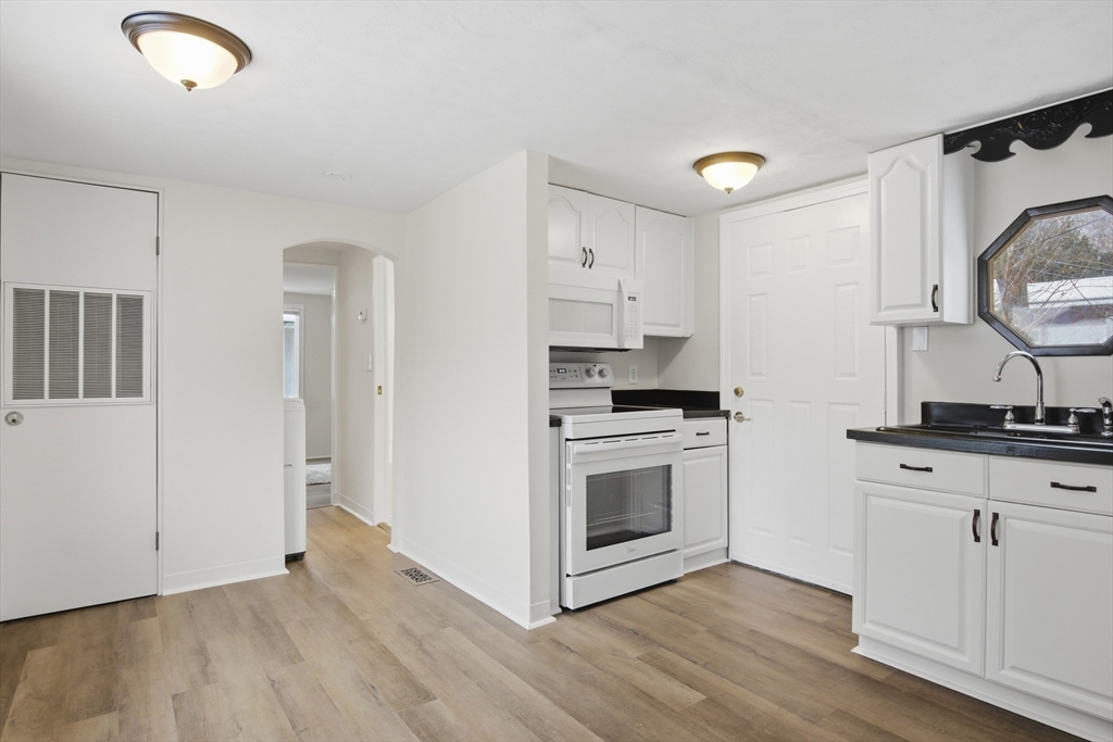 18 Maple Street, Unit 14 Pepperell, MA 01463 - Photo 13 of 27 a kitchen with granite countertop a sink cabinets and stainless steel appliances