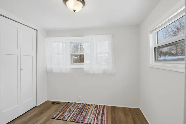 a view of small space with wooden floor and windows
