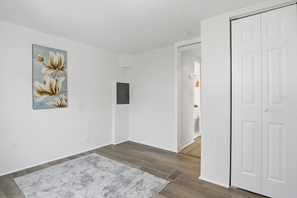 18 Maple Street, Unit 14 Pepperell, MA 01463 - Photo 19 of 27 a view of a hallway with wooden floor and closet