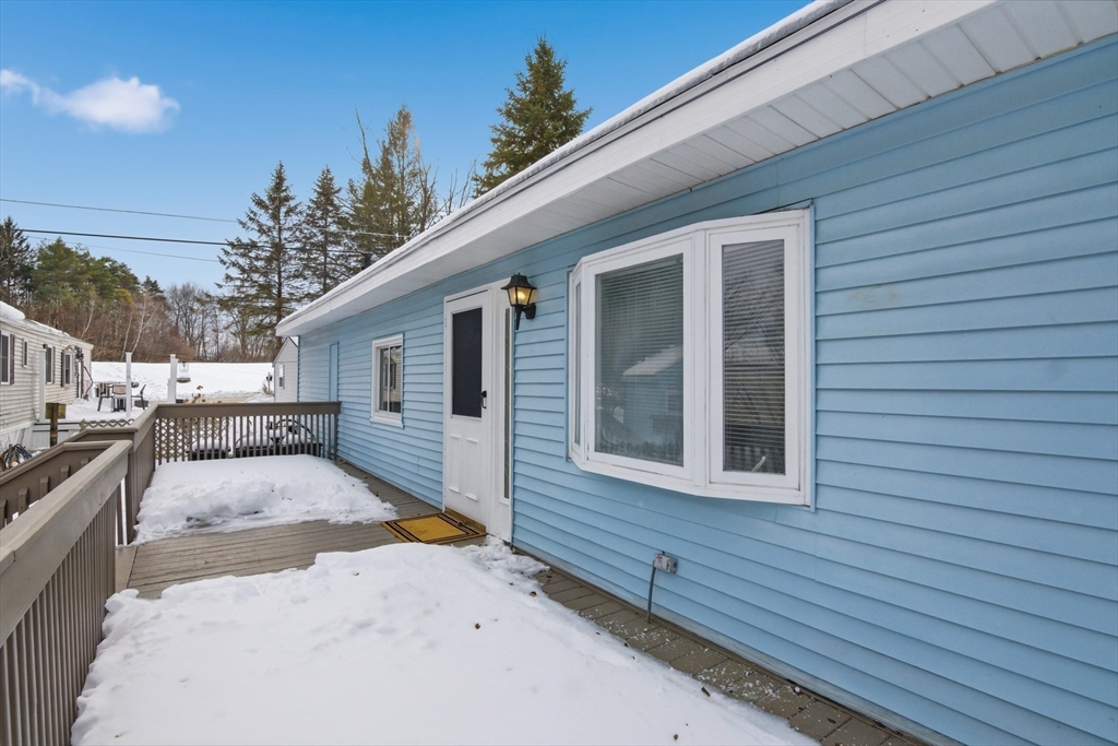 18 Maple Street, Unit 14 Pepperell, MA 01463 - Photo 3 of 27 a view of a house with a wooden fence