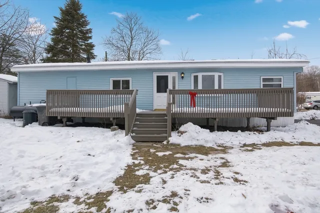 a view of a house with a yard covered in snow