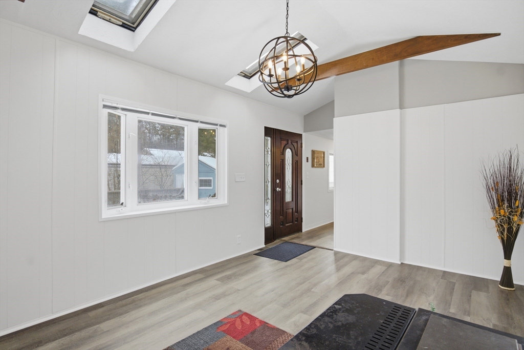 18 Maple Street, Unit 14 Pepperell, MA 01463 - Photo 8 of 27 a view of an empty room with wooden floor and a window