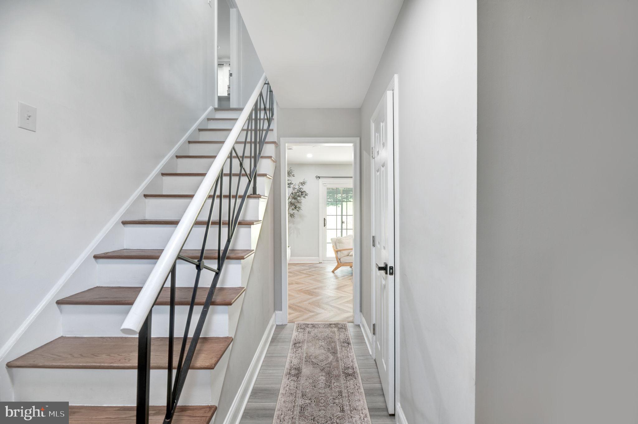 8812 Churchfield Lane Laurel, MD 20708 - Photo 17 of 31 a view of staircase with wooden floor and white walls