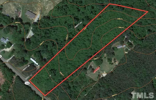 a view of a big yard with lots of bushes